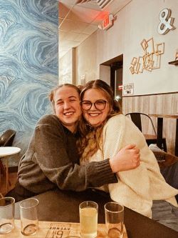 Ashley and friend sitting at a table.